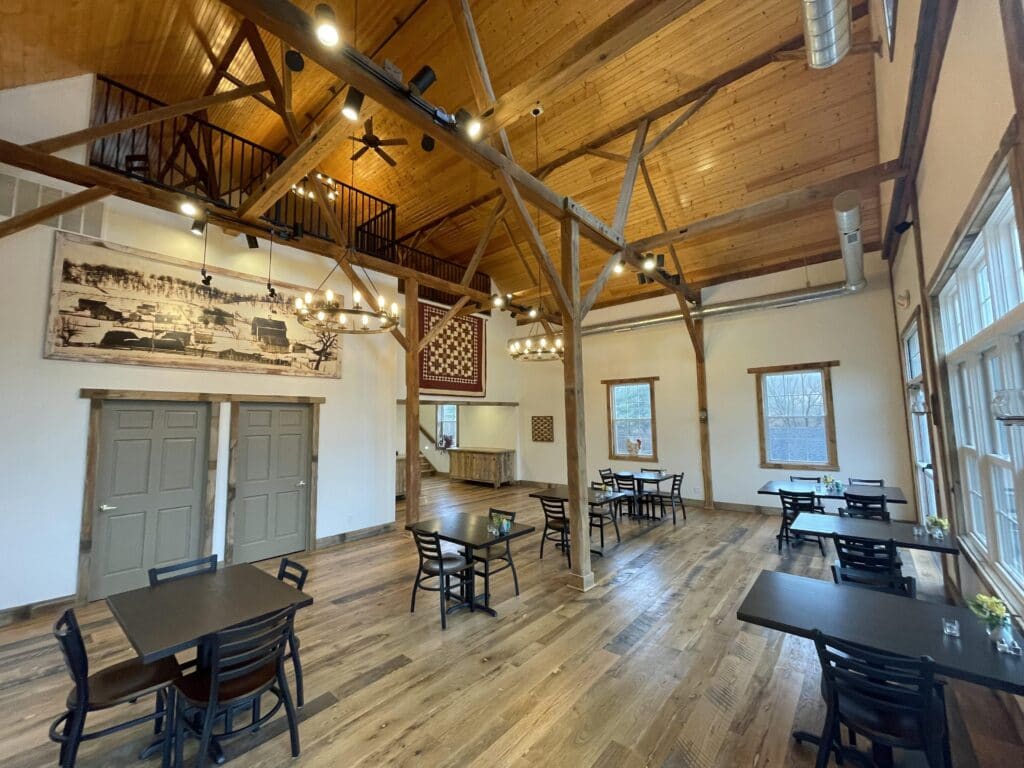 barn space with tables and loft above