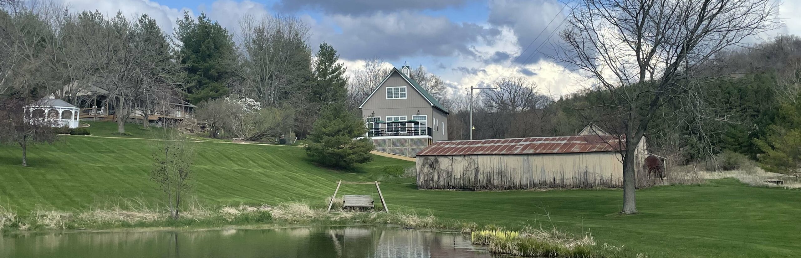 view from pond of barn and main house