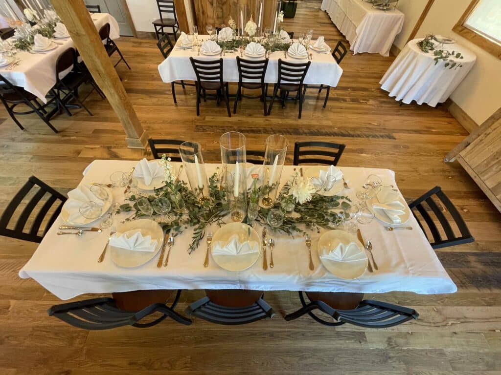 wedding table set with white linens and flowers