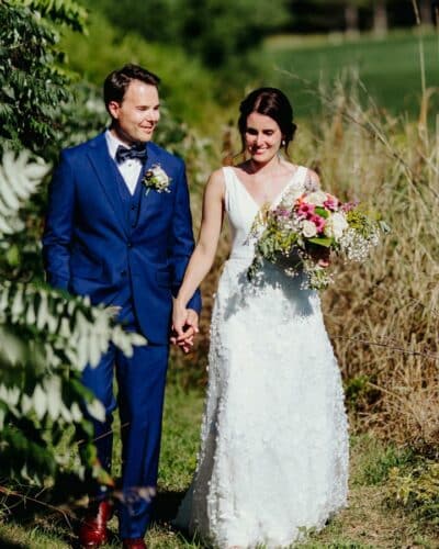 hawkValleyRetreatWeddings couple walking through meadow after stress-free elopement