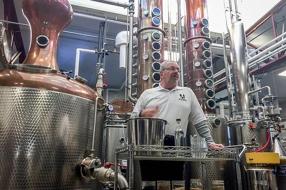 Man giving tour of Blaum Bros. Distillery.
