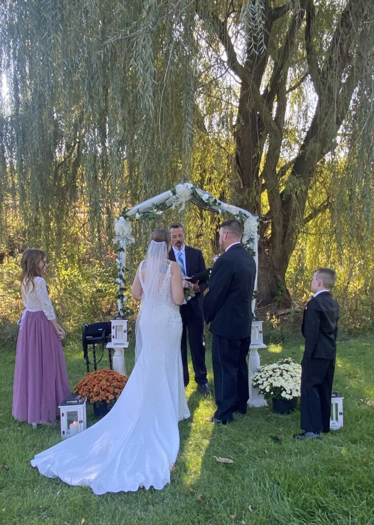 wedding taking place under the willow tree. 