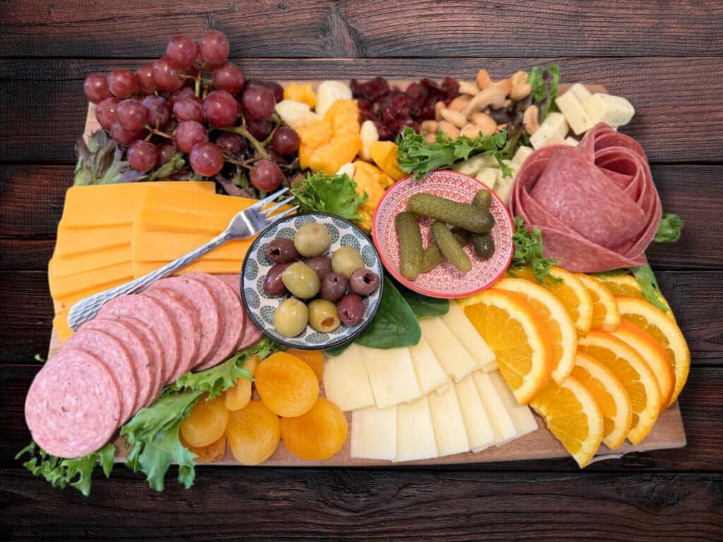 Charcuterie board including meats, cheese, and other treats