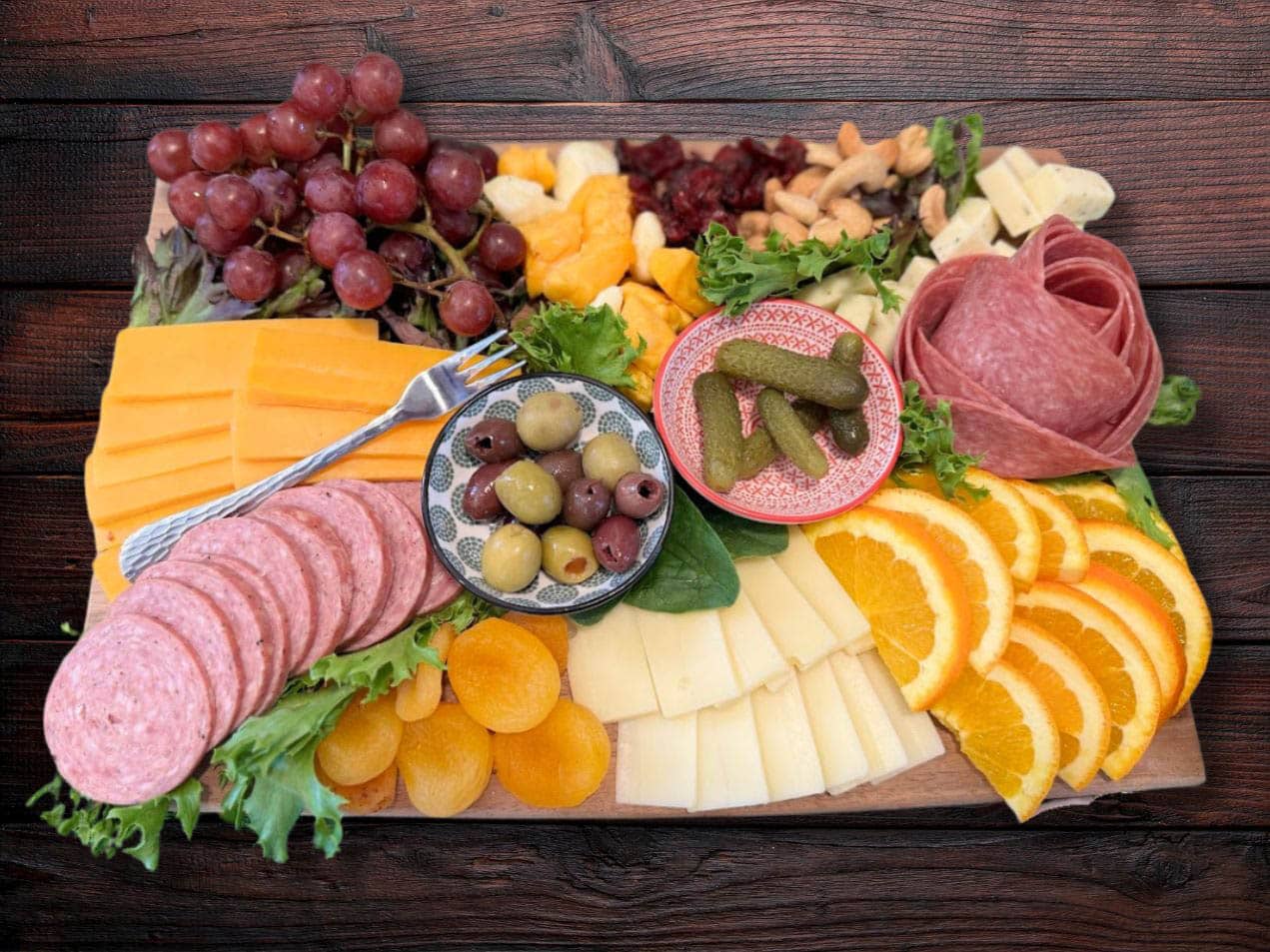 pot of chili , loaf of bread and cheese plate