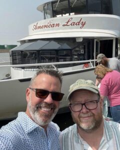 Innkeepers John and Jim in front of the American Lady Cruise Boat