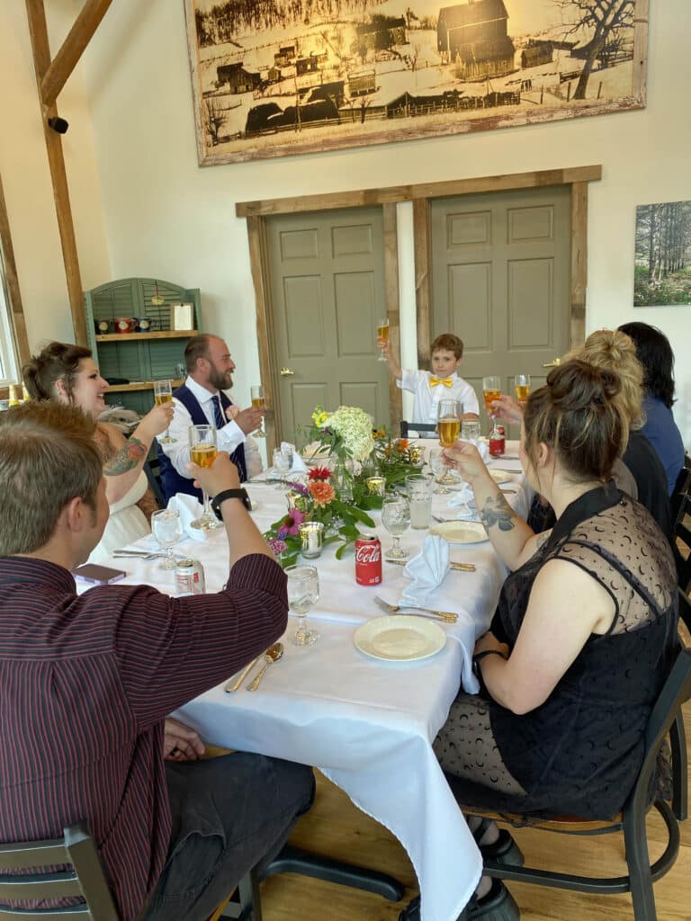 boy toasting wedding family