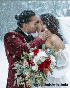 bride and groom in snow with text @weddingsbybelinda