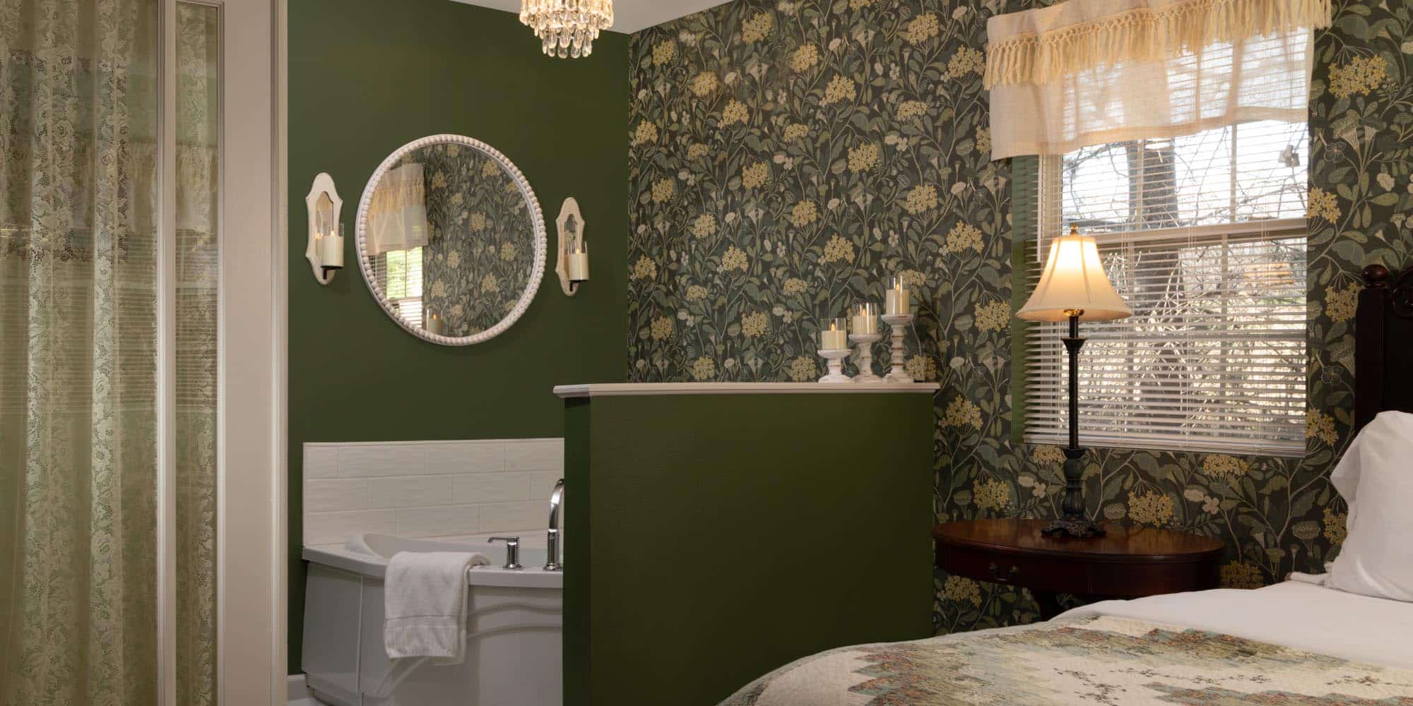 bedroom looking into spa tub alcove with green botanical wallpaer